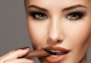 Glamour beautiful woman holds and eats  chocolate candy